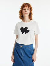A lady wears a heart-printed shirt.